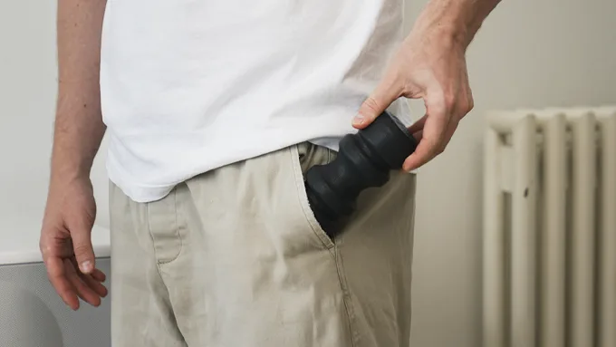 The Travel Roller being slipped into the front pocket of a pair of trousers