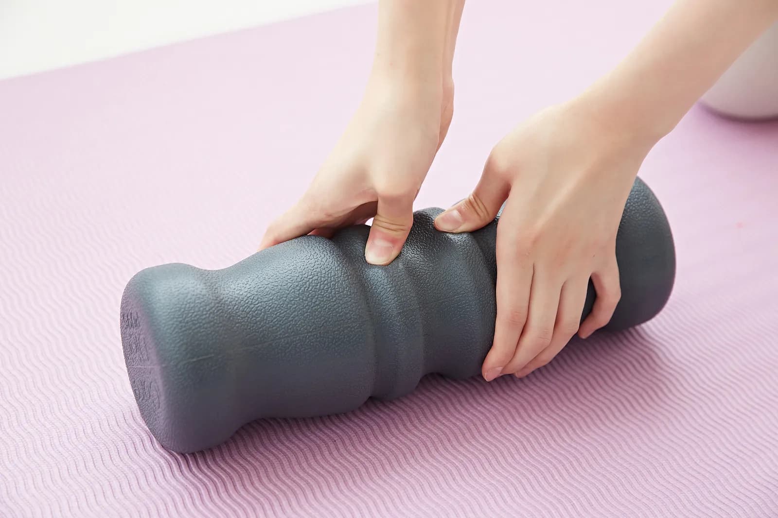 Two hands pressing into the PU95 on a mat to show how the surface gives